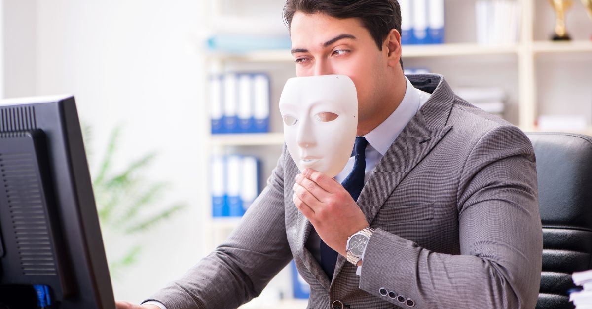 Man holding a mask indicating a possible fraudalent deal